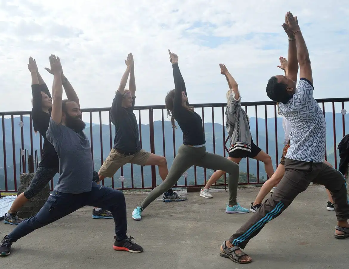 yoga students doing asana at yoga school terrace